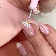 Nail artist applying detailed nail art with vibrant colors and patterns, hands resting on a clean workspace, conveying a creative and lively atmosphere